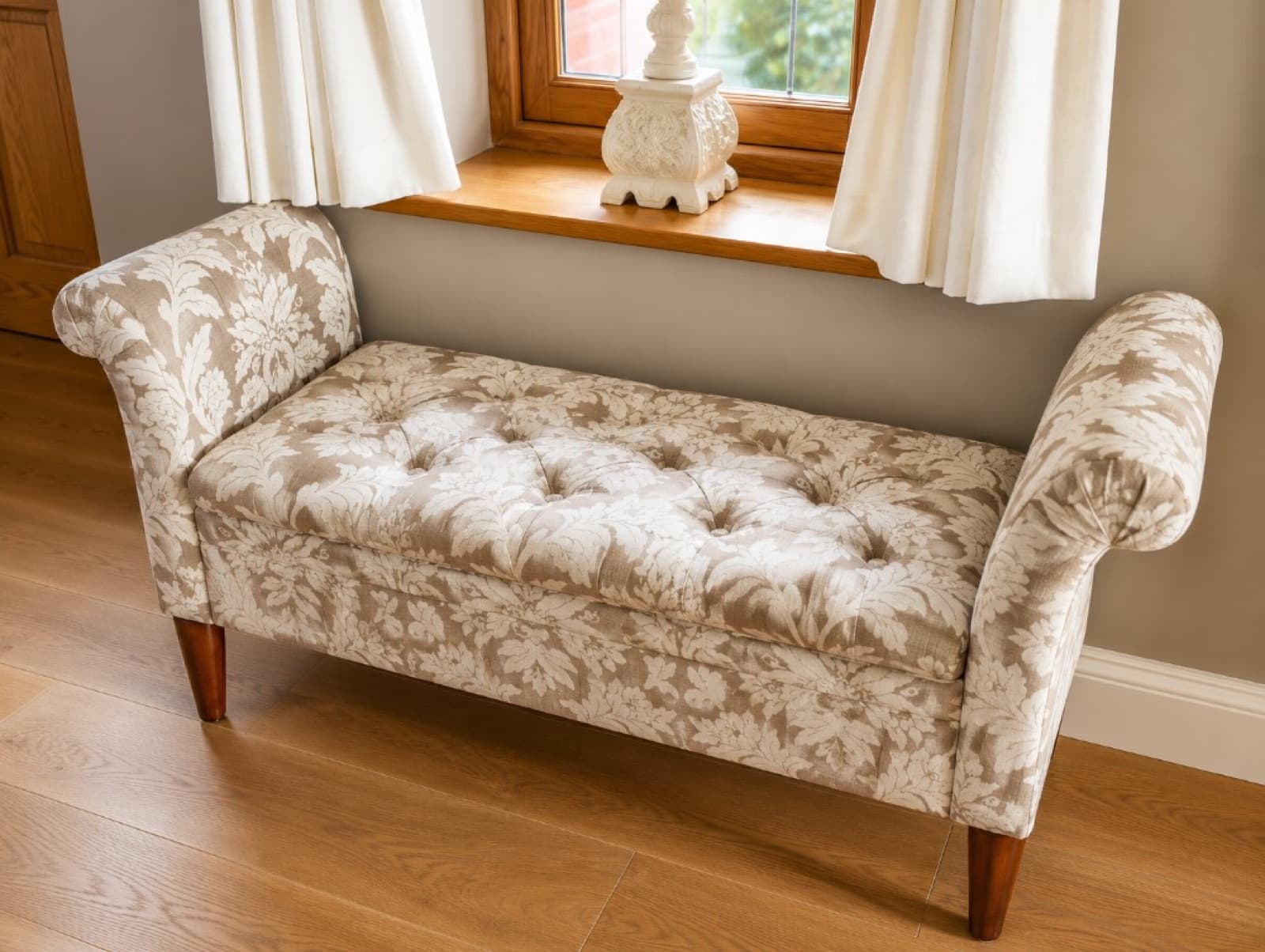 Button-tufted window bench in cream and taupe floral damask fabric