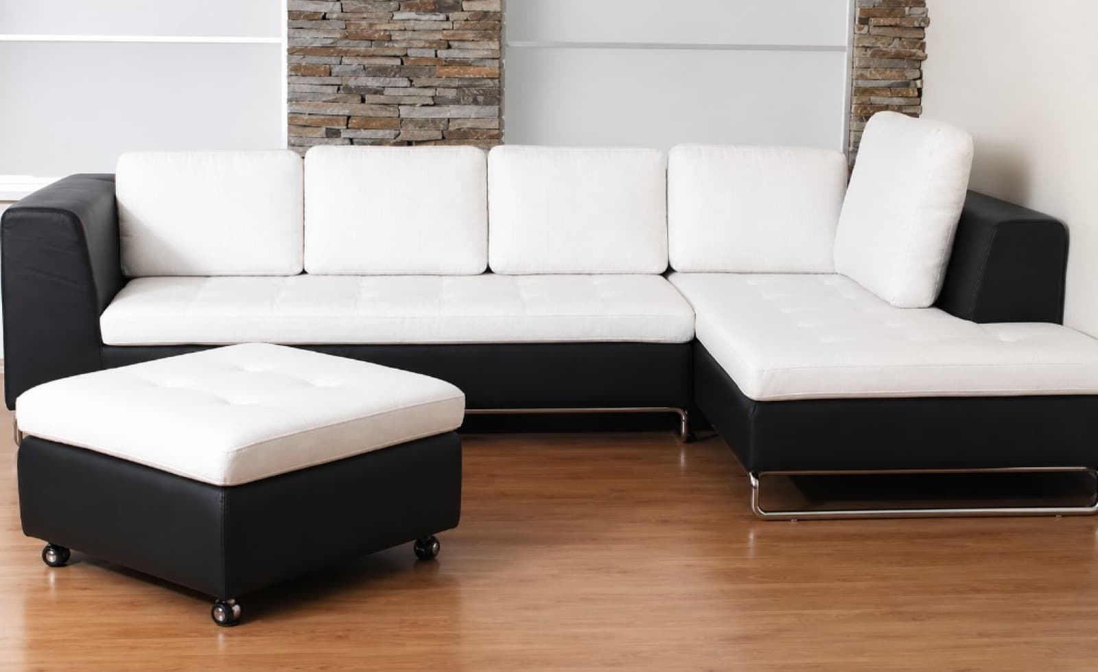 Modern black and white L-shaped sectional sofa with matching ottoman