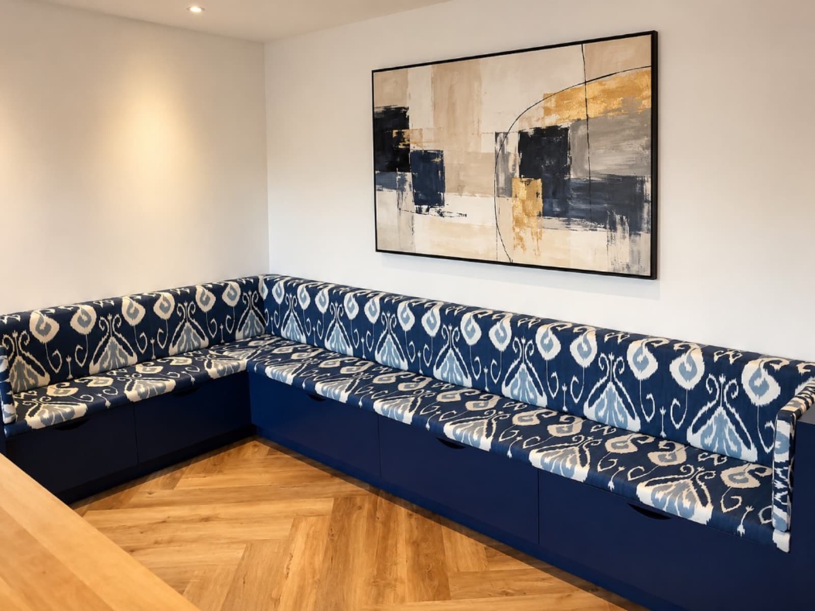 L-shaped navy banquette with blue and white patterned cushions