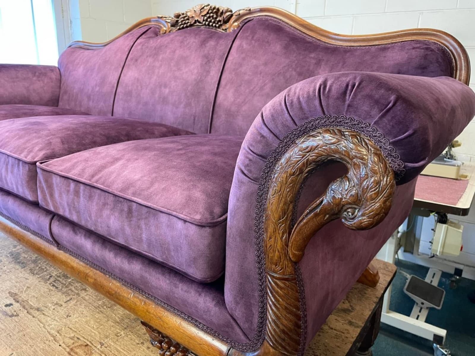 Antique sofa restored in deep purple fabric with carved grape motif frame