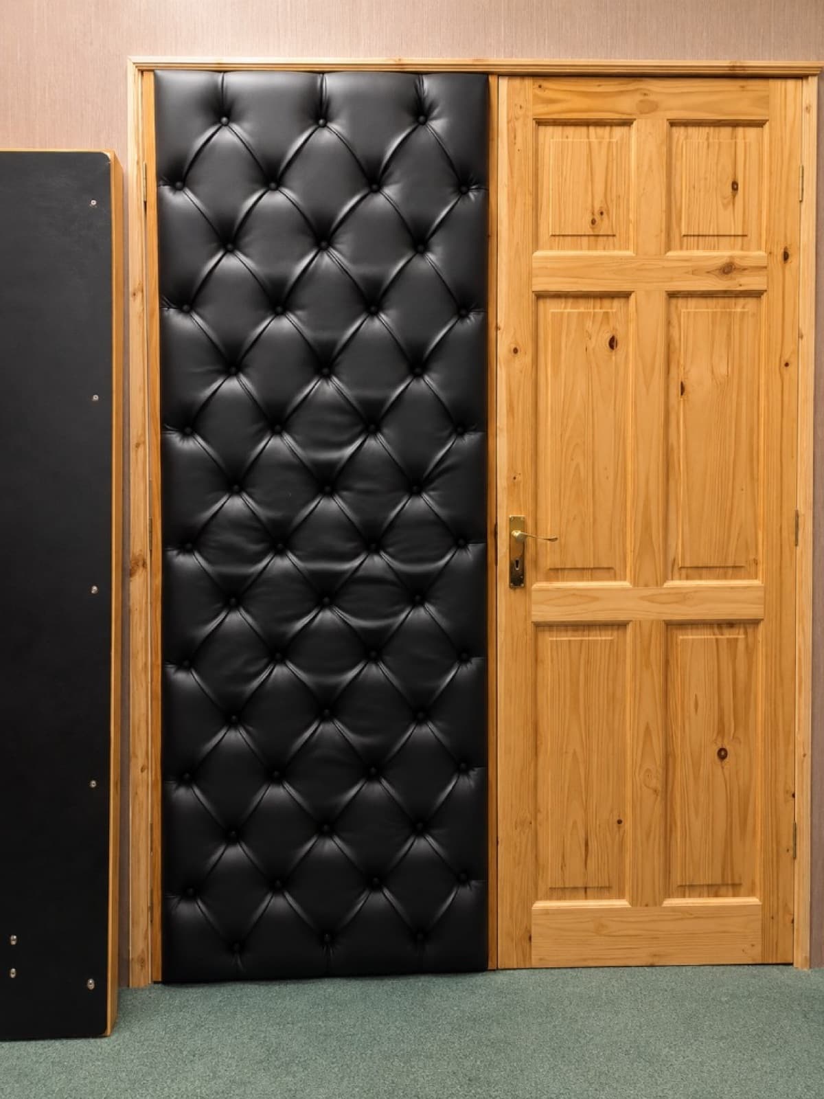 Black button-tufted upholstered door beside a natural wood panel door
