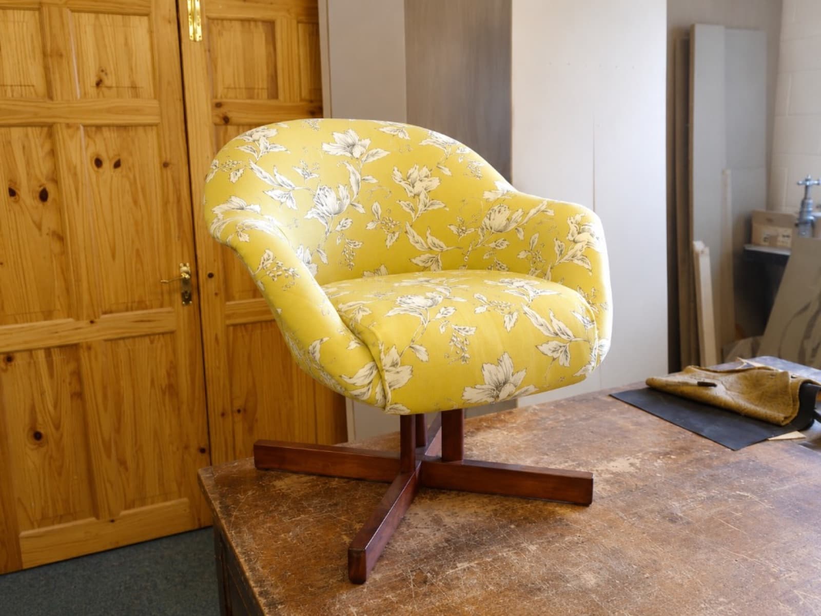 Same swivel tub chair reupholstered in mustard yellow floral fabric