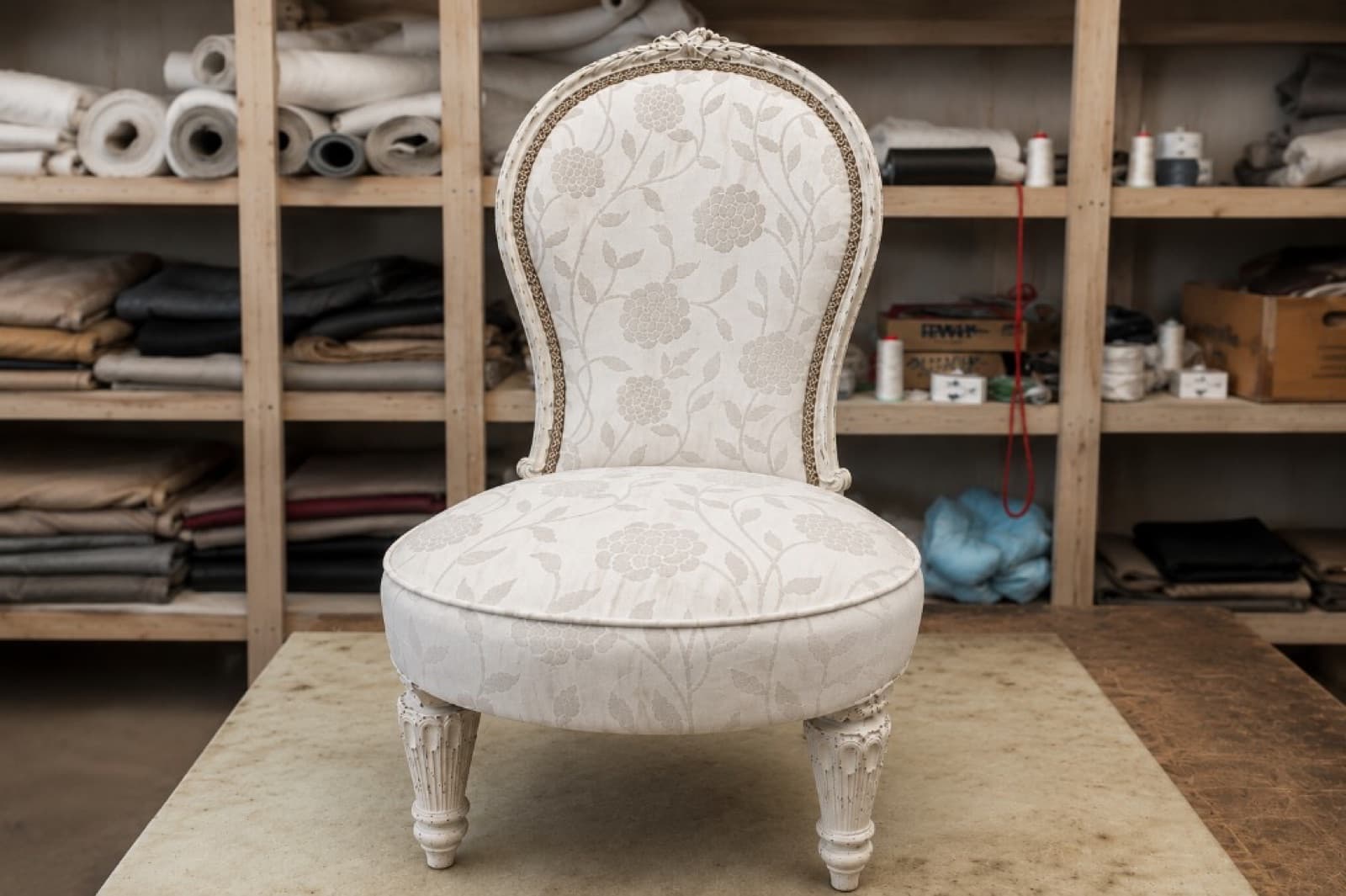 Same Victorian armchair reupholstered in cream floral fabric with painted frame
