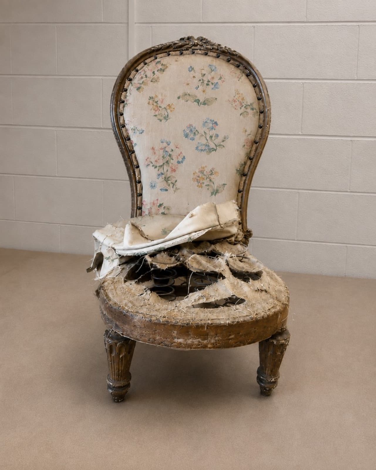 Victorian armchair with shredded seat exposing coil springs before restoration