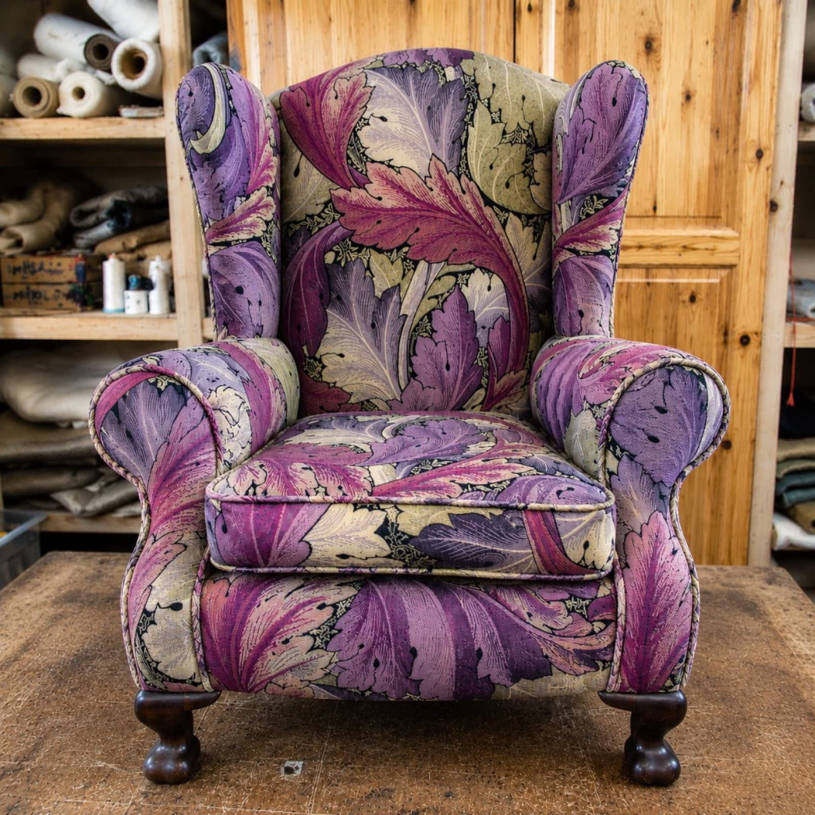 Same wingback armchair reupholstered in a purple and green leaf pattern